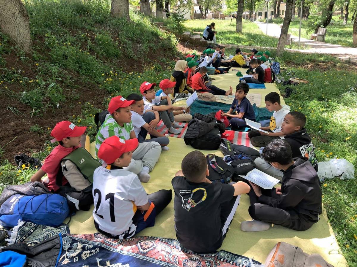 Young participants gathered outdoors during an educational scout activity.
