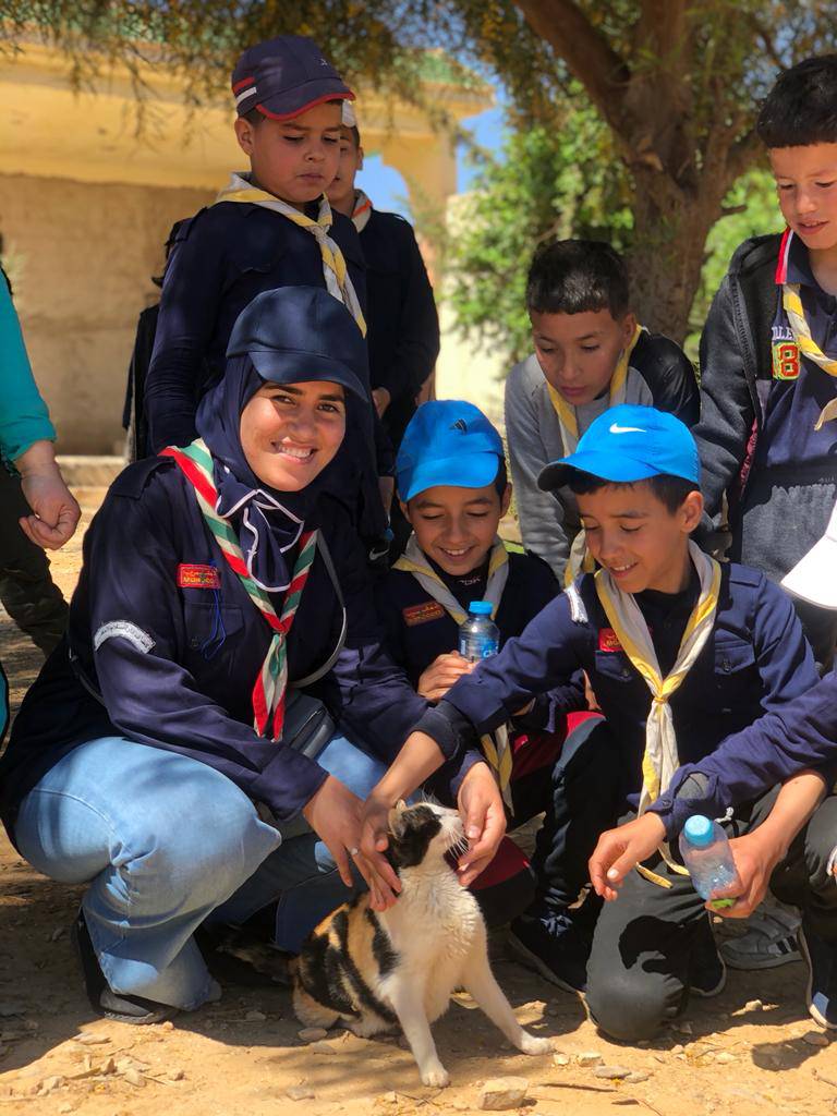Scouts gathering outdoors during a volunteering activity in the community.
